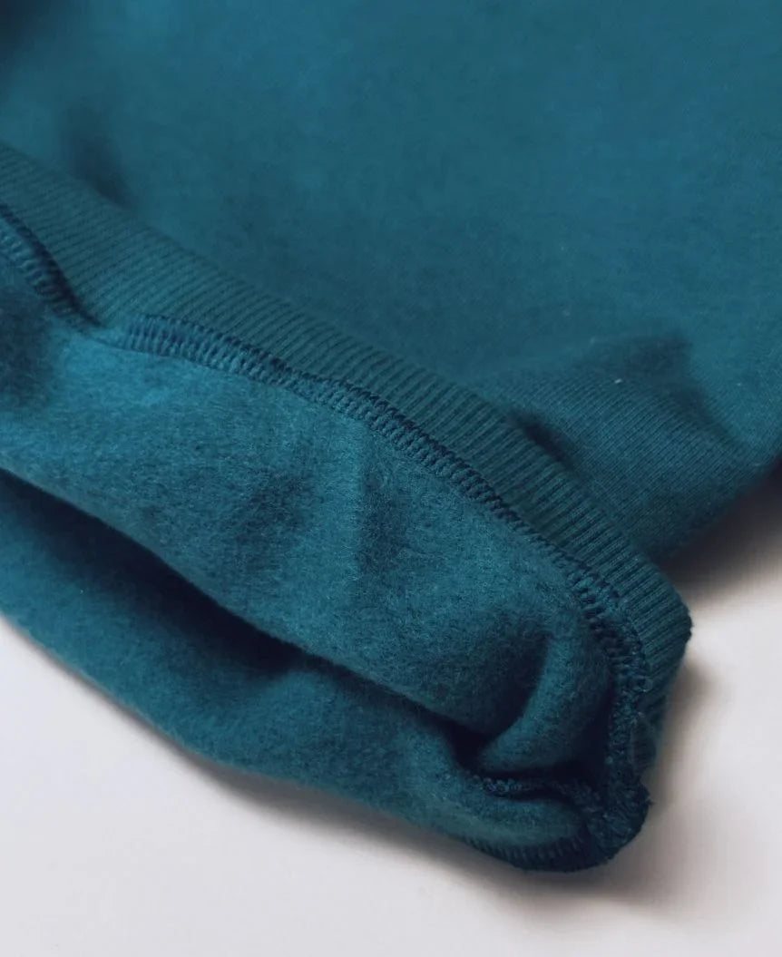 Criança vestindo Moletom Deep Green MiniMalista — look infantil verde escuro estilo Pinterest, blusa de frio unissex peluciada, casaco aconchegante para bebê e criança, moda infantil escandinava